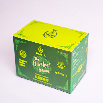 A green and yellow-green cardboard box of Olitia The Olive Leaf Saladin Classic Olive, photographed on a clean white background.